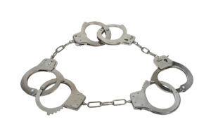 Three strikes handcuffs shown by three sets of handcuffs made of metal with mechanical clasps interlinked - path included